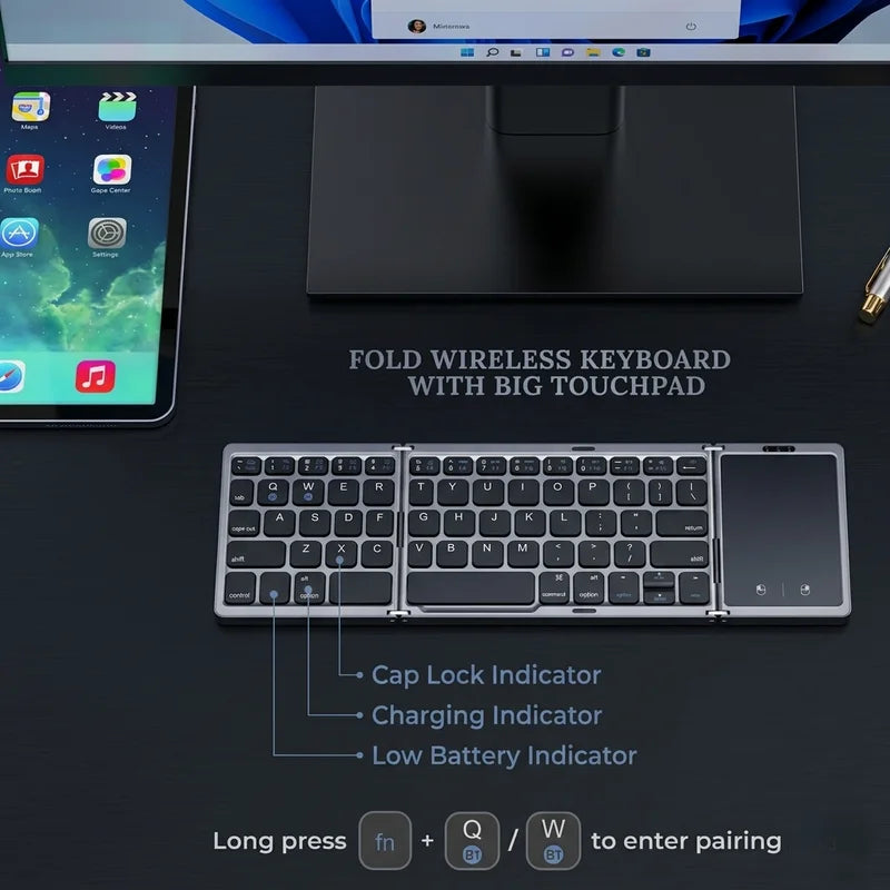 Foldable wireless keyboard with touchpad on a desk setup with a computer and tablet.
